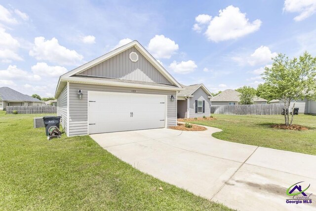 122 Milford Cir, Perry, GA 31069 - view of front of house with fence, board and batten siding, driveway, and a front yard