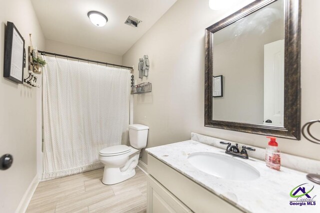 122 Milford Cir, Perry, GA 31069 - bathroom featuring toilet, baseboards, visible vents, and vanity