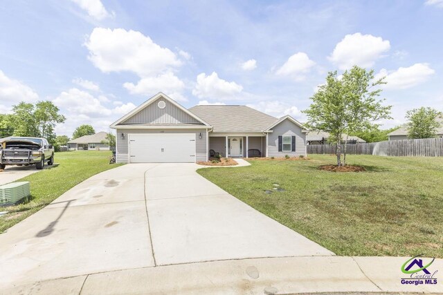 122 Milford Cir, Perry, GA 31069 - ranch-style house with an attached garage, a front lawn, fence, and driveway