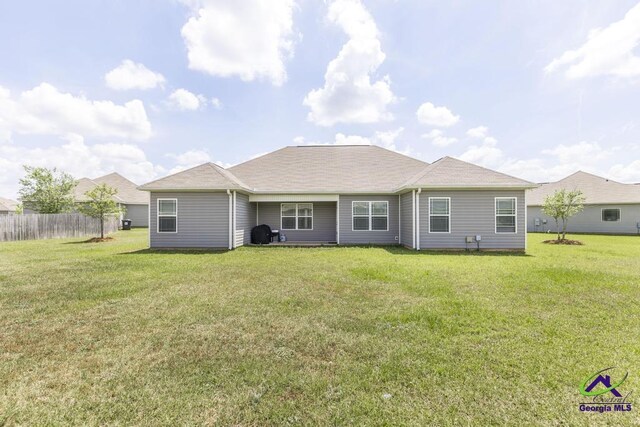 122 Milford Cir, Perry, GA 31069 - rear view of property with a lawn and fence