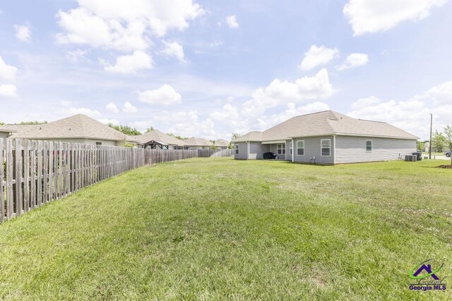 122 Milford Cir, Perry, GA 31069 - view of yard with central AC and a fenced backyard