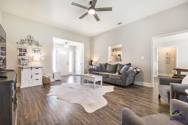 122 Milford Cir, Perry, GA 31069 - living area featuring a ceiling fan, baseboards, visible vents, and dark wood-style floors