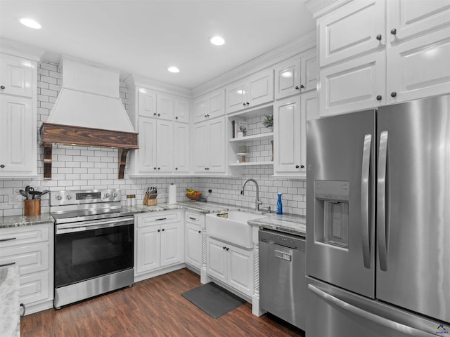 kitchen with a sink, white cabinets, custom exhaust hood, and stainless steel appliances
