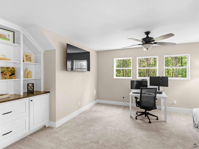 home office with ceiling fan, light colored carpet, plenty of natural light, and baseboards