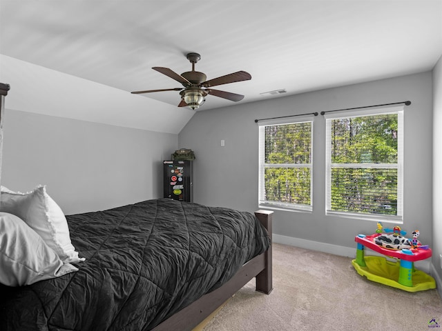 carpeted bedroom featuring visible vents, baseboards, ceiling fan, and lofted ceiling