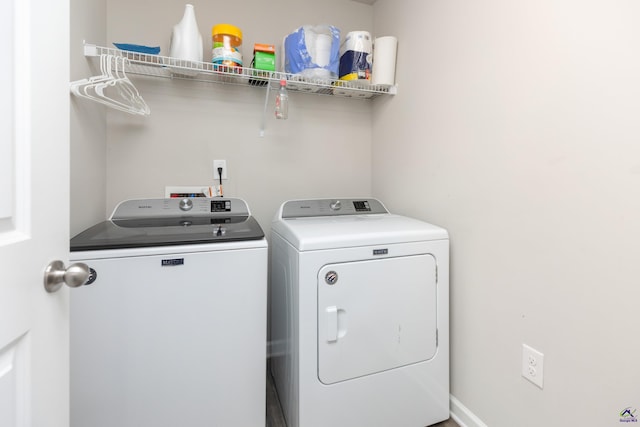 washroom with washing machine and clothes dryer and laundry area