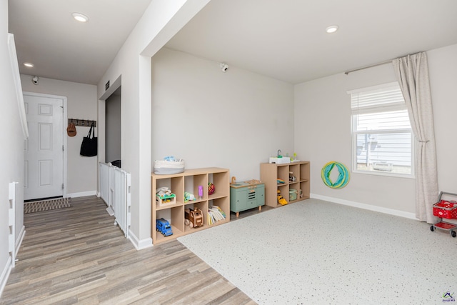 recreation room featuring baseboards, recessed lighting, and wood finished floors