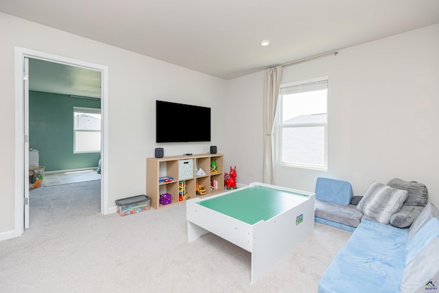 game room featuring baseboards, carpet, and a healthy amount of sunlight