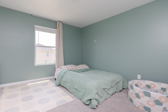 bedroom featuring baseboards and carpet flooring