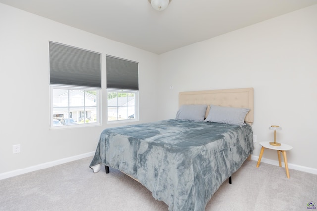 bedroom featuring baseboards and carpet