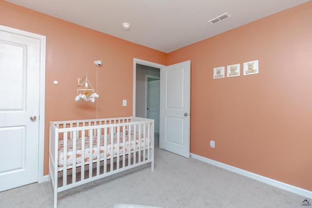 bedroom with carpet floors, baseboards, a nursery area, and visible vents