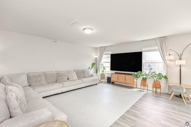 living room featuring visible vents and wood finished floors