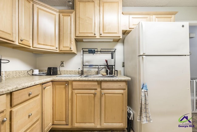 410 Steeplechase Rd, Macon, GA 31216 - kitchen featuring freestanding refrigerator, a sink, light brown cabinetry, and light countertops