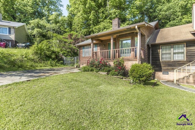 410 Steeplechase Rd, Macon, GA 31216 - view of front of home with a porch, a front lawn, and a chimney