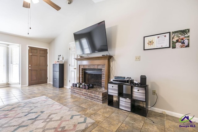 410 Steeplechase Rd, Macon, GA 31216 - living room featuring ceiling fan, a brick fireplace, stone finish floor, baseboards, and vaulted ceiling