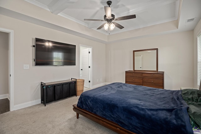 bedroom featuring a ceiling fan, visible vents, light colored carpet, baseboards, and a tray ceiling