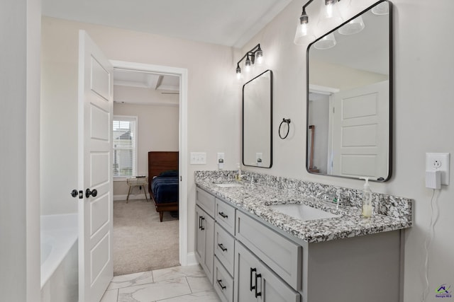 ensuite bathroom with double vanity, a sink, marble finish floor, and ensuite bathroom