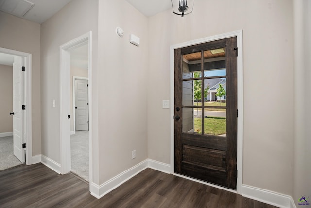 entrance foyer featuring dark wood-style flooring, baseboards, and visible vents