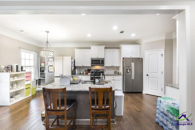 kitchen featuring white cabinets, appliances with stainless steel finishes, a sink, dark wood-type flooring, and visible vents