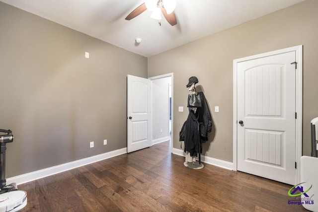 unfurnished bedroom featuring baseboards, ceiling fan, and wood finished floors