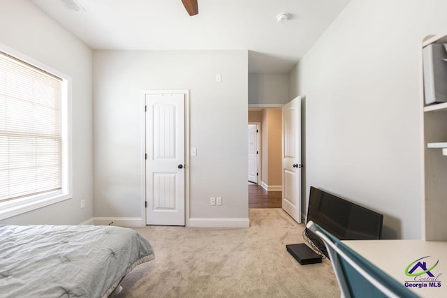 bedroom with carpet floors, multiple windows, baseboards, and ceiling fan