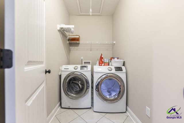 washroom featuring laundry area, baseboards, attic access, independent washer and dryer, and light tile patterned floors