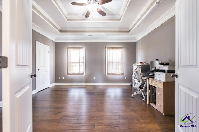 home office featuring ornamental molding, a raised ceiling, ceiling fan, and dark wood finished floors