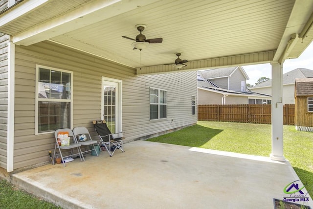 view of patio with ceiling fan and fence