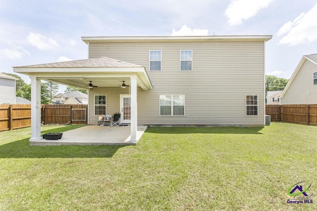 back of property with a fenced backyard, a ceiling fan, a lawn, and a patio area