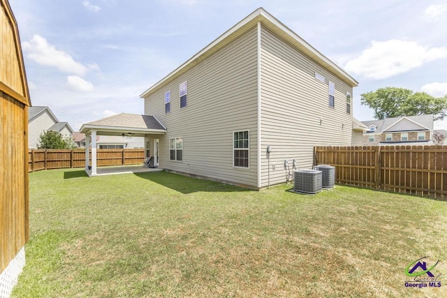 back of property featuring a fenced backyard, a patio area, a yard, and central AC unit