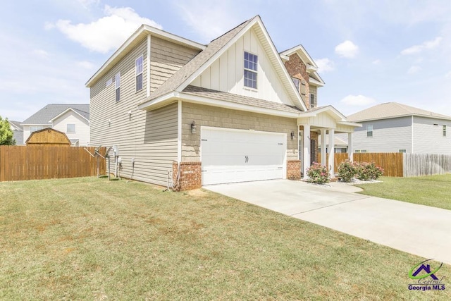 view of front of property with fence, board and batten siding, a front lawn, and a garage