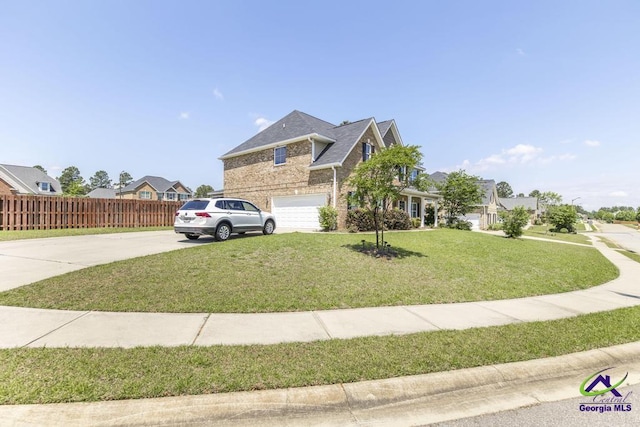 view of front of property with fence, a front yard, brick siding, concrete driveway, and an attached garage