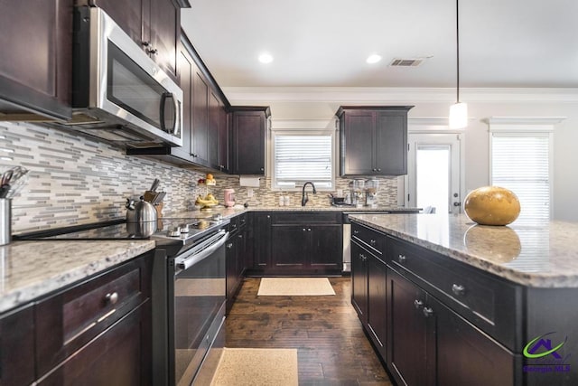 kitchen featuring electric range, visible vents, crown molding, stainless steel microwave, and dark wood-style floors