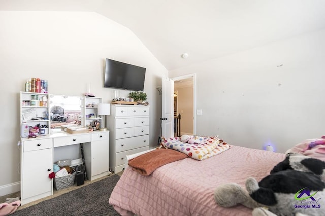 carpeted bedroom with lofted ceiling