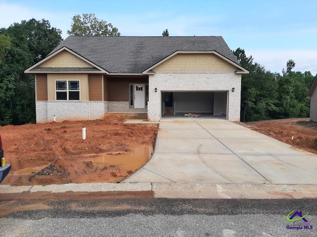 view of front of house with concrete driveway, brick siding, and an attached garage