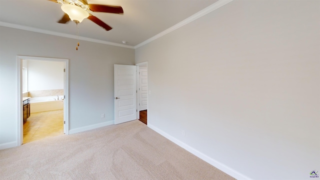 unfurnished bedroom with a ceiling fan, light colored carpet, baseboards, ornamental molding, and ensuite bath