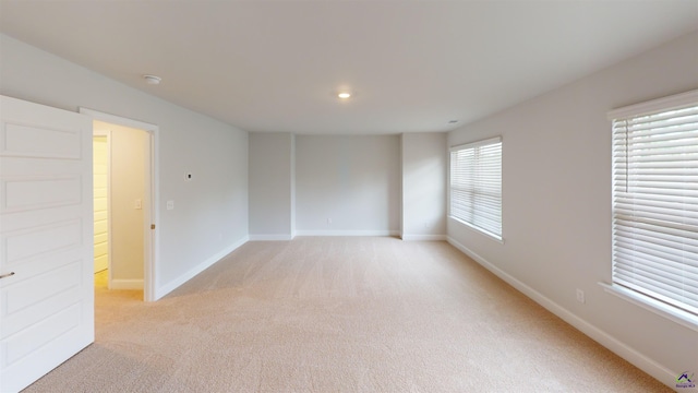 unfurnished room featuring light colored carpet, recessed lighting, and baseboards