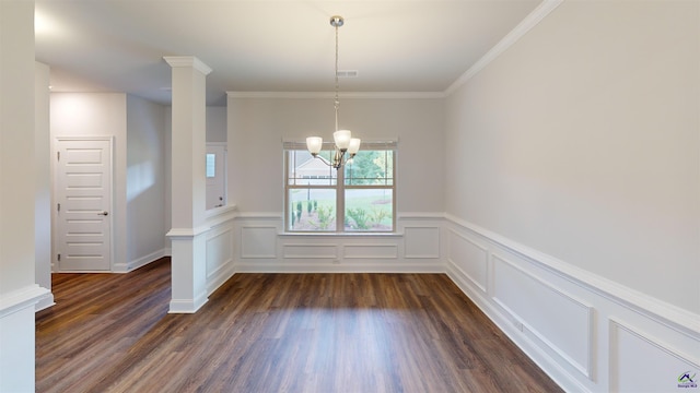 unfurnished dining area featuring dark wood-style flooring, a decorative wall, a chandelier, a wainscoted wall, and ornamental molding