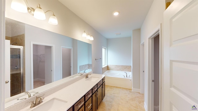 bathroom with double vanity, a sink, a garden tub, and a stall shower