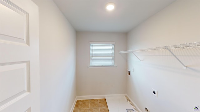 clothes washing area with laundry area, baseboards, washer hookup, light tile patterned floors, and hookup for an electric dryer