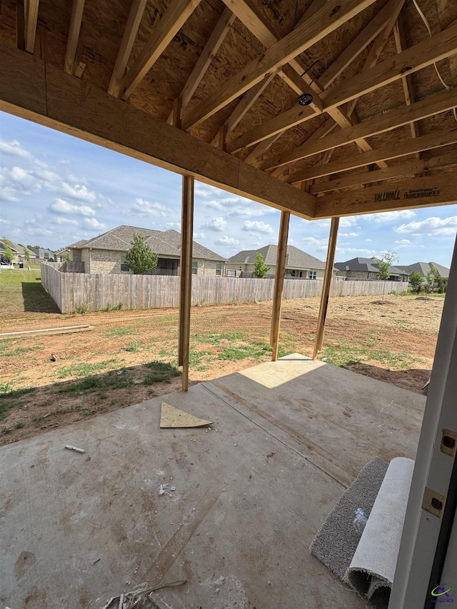 view of patio featuring fence and a residential view