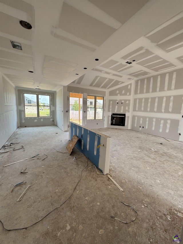 unfurnished living room featuring plenty of natural light and a fireplace