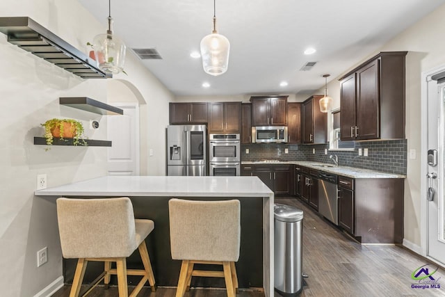 5768 Grande River Rd, Atlanta, GA 30349 - kitchen featuring stainless steel appliances, dark brown cabinetry, visible vents, and open shelves