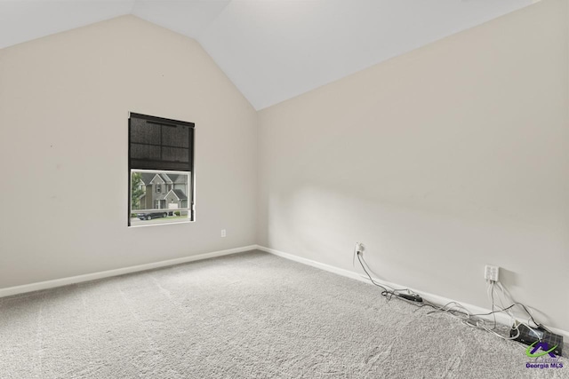 5768 Grande River Rd, Atlanta, GA 30349 - carpeted empty room with baseboards and lofted ceiling
