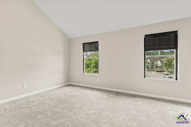 5768 Grande River Rd, Atlanta, GA 30349 - carpeted empty room with baseboards and lofted ceiling