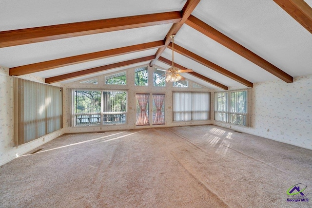 unfurnished living room featuring wallpapered walls, a ceiling fan, carpet flooring, and a wealth of natural light