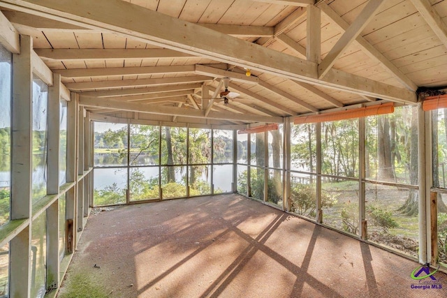 unfurnished sunroom with a ceiling fan and a water view