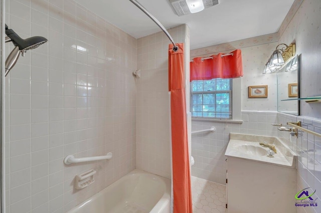 bathroom featuring vanity, visible vents, and shower / tub combo