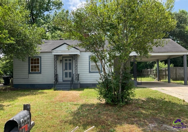 view of front of property with fence, a front yard, driveway, and crawl space