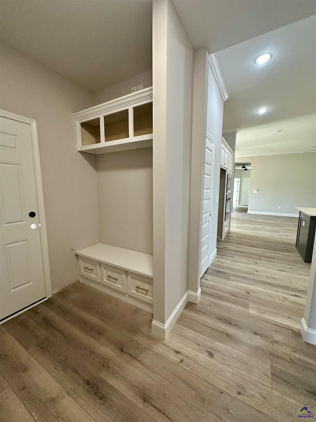 mudroom with recessed lighting, baseboards, and light wood finished floors